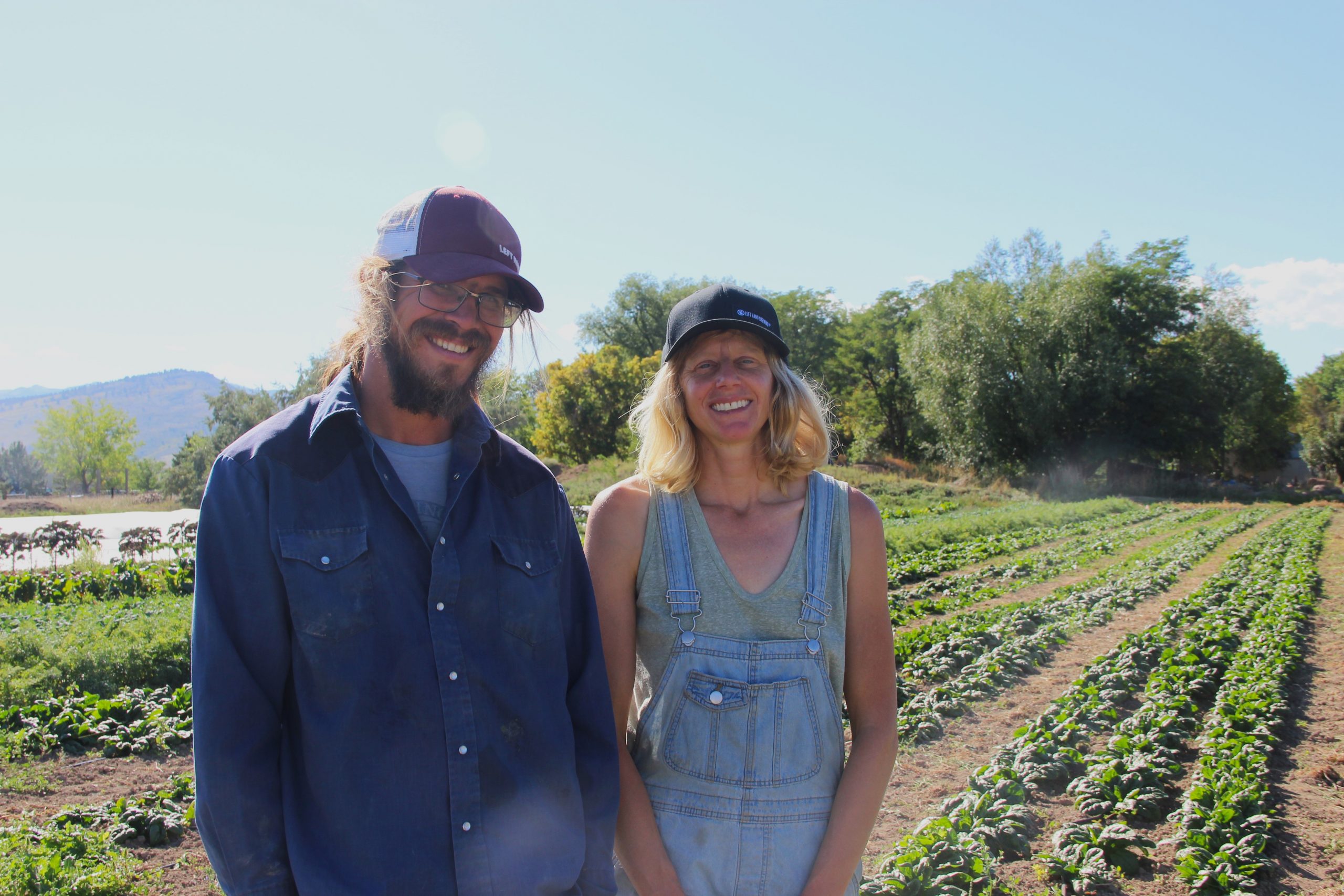 Laura and Dave smile together on their farm in Longmont